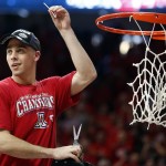 Arizona guard T.J. McConnell cuts down part of the net after defeating Stanford 91-69 and winning the Pac-12 conference after an NCAA college basketball game, Saturday, March 7, 2015, in Tucson, Ariz. (AP Photo/Rick Scuteri)
