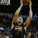Phoenix Suns' Devin Booker grabs a rebound over the New Orleans Pelicans during the first half of an NBA summer league basketball game Sunday, July 19, 2015, in Las Vegas. (AP Photo/John Locher)

