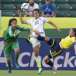 United States' Carli Lloyd (10) goes after t the ball between Colombia's Natalia Gaitan (3) and goalkeeper Stefany Castano (1) during second half FIFA Women's World Cup round of 16 soccer action in Edmonton, Alberta, Canada, Monday, June 22, 2015. (Jason Franson/The Canadian Press via AP)