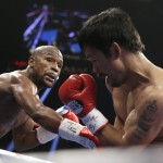 Floyd Mayweather Jr., left, trades blows with Manny Pacquiao, from the Philippines, during their welterweight title fight on Saturday, May 2, 2015 in Las Vegas. (AP Photo/Isaac Brekken)