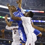 Kentucky guard James Young (1) dunks between Connecticut forward DeAndre Daniels (2) and center Amida Brimah (35) during the second half of the NCAA Final Four tournament college basketball championship game Monday, April 7, 2014, in Arlington, Texas. (AP Photo/David J. Phillip)