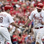 St. Louis Cardinals' Matt Adams, right, is congratulated by teammate Peter Bourjos after scoring on a single by Jason Heyward during the fourth inning of a baseball game against the Arizona Diamondbacks, Monday, May 25, 2015, in St. Louis. (AP Photo/Jeff Roberson)