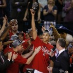 Arizona's Brandon Ashley holds up the most outstanding player of the tournament trophy after Arizona defeated Oregon in an NCAA college basketball game in the championship of the Pac-12 conference tournament Saturday, March 14, 2015, in Las Vegas. (AP Photo/John Locher)