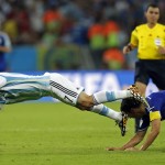  Argentina's Angel di Maria, left, falls after a challenge from Bosnia's Emir Spahic during the group F World Cup soccer match between Argentina and Bosnia at the Maracana Stadium in Rio de Janeiro, Brazil, Sunday, June 15, 2014. (AP Photo/Victor R. Caivano)