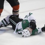 Dallas Stars' Ryan Garbutt falls to the ice after he was checked by Anaheim Ducks' Bryan Allen during the third period in Game 1 of the first-round NHL hockey Stanley Cup playoff series on Wednesday, April 16, 2014, in Anaheim, Calif. The Ducks won 4-3. (AP Photo/Jae C. Hong)
