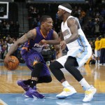 Phoenix Suns guard Eric Bledsoe, left, works against Denver Nuggets guard Ty Lawson during the first quarter of an NBA basketball game Wednesday, Feb. 25, 2015, in Denver. (AP Photo/David Zalubowski)