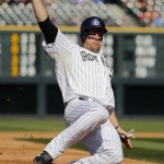 Colorado Rockies' Justin Morneau slides safely into third during the third inning of a baseball game against the Arizona Diamondbacks, Saturday, Sept. 20, 2014, in Denver. (AP Photo/Jack Dempsey)