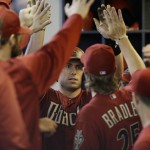 Arizona Diamondbacks' Paul Goldschmidt gets high-fives in the dugout after his home run against the Milwaukee Brewers during the first inning of a baseball game Sunday, May 31, 2015, in Milwaukee. (AP Photo/Jeffrey Phelps)