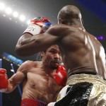 Manny Pacquiao, left, from the Philippines, trades blows with Floyd Mayweather Jr., during their welterweight title fight on Saturday, May 2, 2015 in Las Vegas. (AP Photo/John Locher)