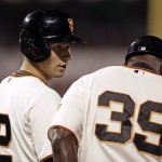 San Francisco Giants' Joe Panik, left, speaks with first base coach Roberto Kelly after Panik's fifth hit of the night against the Arizona Diamondbacks, in the eighth inning of a baseball game Tuesday, Sept. 9, 2014, in San Francisco. The Giants won 5-1. (AP Photo/Ben Margot)