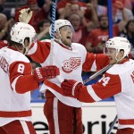Detroit Red Wings center Riley Sheahan, center, celebrates his goal against the Tampa Bay Lightning with Justin Abdelkader, left, and Gustav Nyquist, right, during the first period of Game 5 of a first-round NHL Stanley Cup hockey playoff series Saturday, April 25, 2015, in Tampa, Fla. (AP Photo/Chris O'Meara)