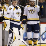 Nashville Predators' Pekka Rinne (35), of Finland, and Shea Weber, right, stand next to one another during a break in the action during the first period of an NHL hockey game against the Arizona Coyotes Monday, March 9, 2015, in Glendale, Ariz. (AP Photo/Ross D. Franklin)
