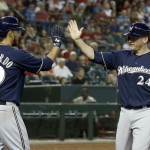 
Milwaukee Brewers' Lyle Overbay (24) gets a high-five from teammate Yovani Gallardo (49) after Overbay scored a run against the Arizona Diamondbacks during the fifth inning of a baseball game on Thursday, June 19, 2014, in Phoenix. (AP Photo/Ross D. Franklin)
