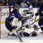 Chicago Blackhawks' Brandon Saad (20) loses his footing as St. Louis Blues goalie Ryan Miller watches during the third period in Game 1 of a first-round NHL hockey Stanley Cup playoff series Thursday, April 17, 2014, in St. Louis. (AP Photo/Jeff Roberson)
