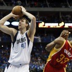 Dallas Mavericks' Dirk Nowitzki (41), of Germany, attempts to shoot after getting by Houston Rockets' Corey Brewer (33) in the second half of Game 3 in an NBA basketball first-round playoff series Friday, April 24, 2015, in Dallas. The Rockets won 130-128. (AP Photo/Tony Gutierrez)