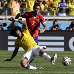 Brazil's Marcelo, front, clears from Chile's Mauricio Pinilla during the World Cup round of 16 soccer match between Brazil and Chile at the Mineirao Stadium in Belo Horizonte, Brazil, Saturday, June 28, 2014. (AP Photo/Andre Penner)