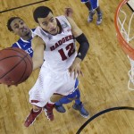 Wisconsin guard Traevon Jackson (12) drives to the basket past Kentucky guard James Young during the second half of an NCAA Final Four tournament college basketball semifinal game Saturday, April 5, 2014, in Arlington, Texas. Kentucky won 74-73. (AP Photo/Chris Steppig, pool)