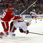 Detroit Red Wings defenseman Marek Zidlicky (28) checks Arizona Coyotes center Sam Gagner (9) off the puck during the first period of an NHL hockey game in Detroit on Tuesday, March 24, 2015. (AP Photo/Paul Sancya)