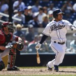San Diego Padres' Alexi Amarista drives a base hit to right field to bring in a run against the Arizona Diamondbacks in the fourth inning of a baseball game Monday, Sept. 1, 2014, in San Diego. (AP Photo/Lenny Ignelzi)
