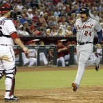 Detroit Tigers' Miguel Cabrera (24) shouts in celebration as he comes in to score as Arizona Diamondbacks' Miguel Montero, left, looks on during the eighth inning of a baseball game on Tuesday, July 22, 2014, in Phoenix. (AP Photo)