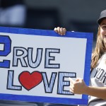  A fan of the New York Yankees' Derek Jeter (2) holds a sign before a pregame ceremony honoring the Yankees captain Derek who is retiring at the end of the season, on Derek Jeter Day at Yankee Stadium in New York, Sunday, Sept. 7, 2014. game (AP Photo/Kathy Willens)