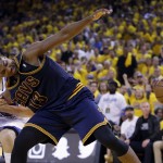 Cleveland Cavaliers center Tristan Thompson (13) loses the ball as he is held by Golden State Warriors center Andrew Bogut during the first half of Game 1 of basketball's NBA Finals in Oakland, Calif., Thursday, June 4, 2015. (AP Photo/Ben Margot)