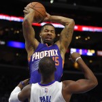 Phoenix Suns forward Marcus Morris, top, grabs a rebound away from Los Angeles Clippers guard Chris Paul during the first half of a preseason NBA basketball game, Wednesday, Oct. 22, 2014, in Los Angeles. (AP Photo/Mark J. Terrill)