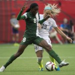 United States' Julie Johnston fights for control of the ball with Nigeria's Asisat Oshoala during the first half of a FIFA Women's World Cup soccer game Tuesday, June 16, 2105, in Vancouver, British Columbia, Canada. (Jonathan Hayward/The Canadian Press via AP)