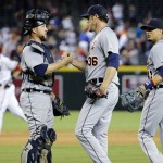 Detroit Tigers catcher Bryan Holaday, left, greets closer Joe Nathan (36) after a baseball game against the Arizona Diamondbacks, Monday, July 21, 2014, in Phoenix. The Tigers won 4-3. At right is Tigers' Victor Martinez. (AP Photo/Matt York)