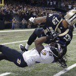 Baltimore Ravens cornerback Lardarius Webb (21) drags down New Orleans Saints wide receiver Joe Morgan (13) with a horse collar tackle near the goal line in the first half of an NFL football game in New Orleans, Monday, Nov. 24, 2014. (AP Photo/Jonathan Bachman)