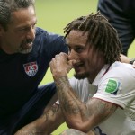 A trainer checks on United States' Jermaine Jones after he was hit in the face with the ball during the World Cup round of 16 soccer match between Belgium and the USA at the Arena Fonte Nova in Salvador, Brazil, Tuesday, July 1, 2014. (AP Photo/Marcio Jose Sanchez)