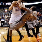 Oklahoma City Thunder center Enes Kanter (34) of Turkey, fouls Phoenix Suns' Brandon Knight (3) during the first half of an NBA basketball game, Thursday, Feb. 26, 2015, in Phoenix. (AP Photo/Matt York)