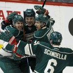 Minnesota Wild left wing Zach Parise, left, celebrates with teammates center Mikael Granlund (64), of Finland, defenseman Jared Spurgeon, and defenseman Marco Scandella (6) after Parise's goal on St. Louis Blues goalie Jake Allen during the first period of Game 6 of an NHL hockey first-round playoff series in St. Paul, Minn., Sunday, April 26, 2015. (AP Photo/Ann Heisenfelt)