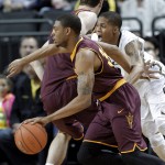 Arizona State guard Jermaine Marshall, left, drives past Oregon guard Joseph Young during the first half of an NCAA college basketball game in Eugene, Ore., Tuesday, March 4, 2014. (AP Photo/Don Ryan)