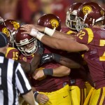 Southern California quarterback Cody Kessler, center, is congratulated by teammates after his touchdown in the second half of an NCAA college football game against Arizona State, Saturday, Oct. 4, 2014, in Los Angeles. Arizona State won 38-34. (AP Photo/Gus Ruelas)