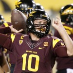 Arizona State's Taylor Kelly throws a pass as he warms up prior to an NCAA college football game against Utah on Saturday, Nov. 1, 2014, in Tempe, Ariz. (Photo/Ross D. Franklin)
