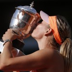 Russia's Maria Sharapova holds the trophy after winning the final of the French Open tennis tournament against Romania's Simona Halep at the Roland Garros stadium, in Paris, France, Saturday, June 7, 2014. Sharapova won in three sets 6-4, 6-7, 6-4. (AP Photo/Michel Euler)