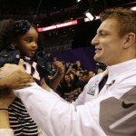 New England Patriots' Rob Gronkowski holds up Chya Mayo during media day for NFL Super Bowl XLIX football game Tuesday, Jan. 27, 2015, in Phoenix. (AP Photo/David J. Phillip)
