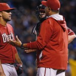 Arizona Diamondbacks pitching coach Mike Harkey, right, confers with relief pitcher Randall Delgado after he gave up an RBI single to Colorado Rockies first baseman Wilin Rosario during the fifth inning of a baseball game Wednesday, June 24, 2015, in Denver. (AP Photo/David Zalubowski)