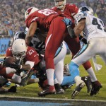 Arizona Cardinals' Marion Grice (23) reaches the ball over the goal line for a touchdown against the Carolina Panthers in the first half of an NFL wild card playoff football game in Charlotte, N.C., Saturday, Jan. 3, 2015. (AP Photo/Mike McCarn)