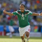  Mexico's Giovani dos Santos celebrates after scoring his side's first goal against Netherlands' goalkeeper Jasper Cillessen during the World Cup round of 16 soccer match between the Netherlands and Mexico at the Arena Castelao in Fortaleza, Brazil, Sunday, June 29, 2014. (AP Photo/Eduardo Verdugo)