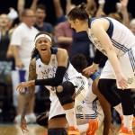 Minnesota Lynx guard Seimone Augustus, left, falls to the floor in celebration with teammate Lindsay Whalen, right, after tying up the score during the second half of Game 2 of the WNBA basketball Western Conference finals against the Phoenix Mercury, Sunday, Aug. 31, 2014, in Minneapolis. The Lynx won 82-77. (AP Photo/The Star Tribune, Kyndell Harkness)
