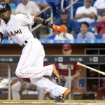 Miami Marlins' Dee Gordon (9) tries to out run a throw to first base after he bunted during the first inning of a baseball game in Miami against the Arizona Diamondbacks, Wednesday, May 20, 2015. (AP Photo/J Pat Carter)