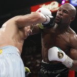Floyd Mayweather Jr., right, trades punches with Marcos Maidana, from Argentina, in their WBC-WBA welterweight title boxing fight Saturday, May 3, 2014, in Las Vegas. (AP Photo/Eric Jamison)