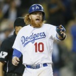 Los Angeles Dodgers' Justin Turner points in celebration after scoring a go-ahead run on a single by Dodgers' Howie Kendrick against the Arizona Diamondbacks during the seventh inning of a baseball game, Saturday, May 2, 2015, in Los Angeles. (AP Photo/Danny Moloshok)