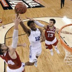 Duke's Justise Winslow (12) goes up for a shot between Wisconsin's Frank Kaminsky (44) and Duje Dukan (13) during the first half of the NCAA Final Four college basketball tournament championship game Monday, April 6, 2015, in Indianapolis. (AP Photo/Chris Steppig, Pool)