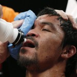 Manny Pacquiao, from the Philippines, is assisted in his corner during his welterweight title fight against Floyd Mayweather Jr. on Saturday, May 2, 2015 in Las Vegas. (AP Photo/John Locher)