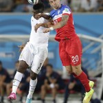 Ghana's Asamoah Gyan, left, and United States' Geoff Cameron jump to head the ball during the group G World Cup soccer match between Ghana and the United States at the Arena das Dunas in Natal, Brazil, Monday, June 16, 2014. (AP Photo/Dolores Ochoa)