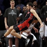 Toronto Raptors' Landry Fields, above, falls over Brooklyn Nets' Shaun Livingston, below as he chased a ball out of bounds during the second half of Game 3 of an NBA basketball first-round playoff series Friday, April 25, 2014, in New York. The Nets won 102-98. (AP Photo/Frank Franklin II)