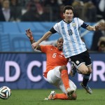 Netherlands' Nigel de Jong, left, challenges Argentina's Lionel Messi during the World Cup semifinal soccer match between the Netherlands and Argentina at the Itaquerao Stadium in Sao Paulo Brazil, Wednesday, July 9, 2014. (AP Photo/Martin Meissner)